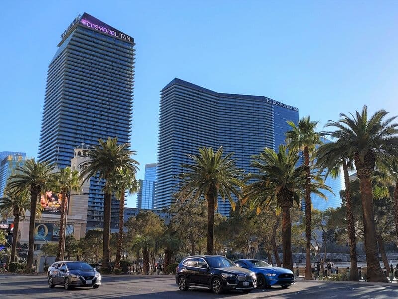 The Cosmopolitan towers beside the Bellagio fountains at night